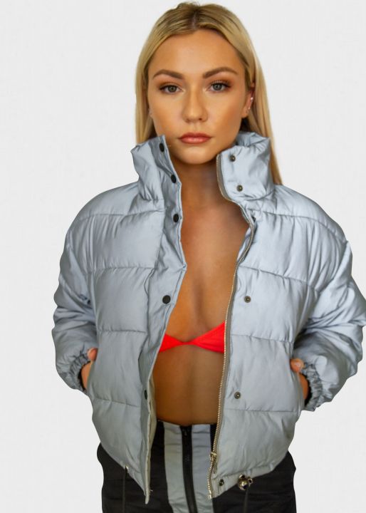 Ready to impress? This reflective puffer jacket seems innocent enough. Under natural light, it’s an unassuming grey.